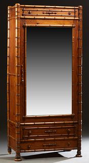 English Pitch Pine Faux Bamboo Armoire, c. 1880, the applied carving top over a single mirror door, opening to an interior with two shelves, on a base