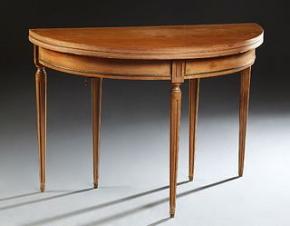 French Louis XVI Style Demilune Carved Mahogany Breakfast Table, early 20th c., the folding circular top over a brass mounted skirt, on tapered reeded