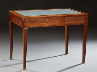 French Louis XVI Style Carved Mahogany Marble Top Writing Table, early 20th c., with an inset gray marble top over a wide skirt with a frieze drawer o