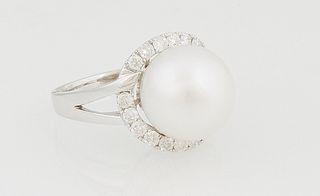 Lady's 14K Yellow Gold Dinner Ring, with a 13mm white Tahitian cultured pearl, atop a border of round diamonds, on a split band, total diamond wt.- .6