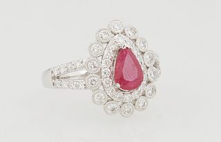 Lady's Platinum Dinner Ring, with a pear shaped 1.33 ct. ruby, atop a double graduated concentric band of round diamonds, the split shoulders of the b