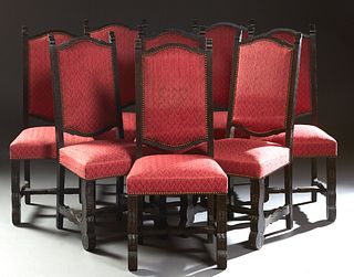 Set of Eight Spanish Carved Oak Upholstered Dining Chairs, 20th c., the arched backs over upholstered seats on thick cabriole legs joined by shaped st