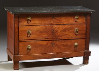 French Provincial Empire Style Carved Walnut Marble Top Commode, 19th c., the figured black marble over three graduated drawers, with lions' head ring