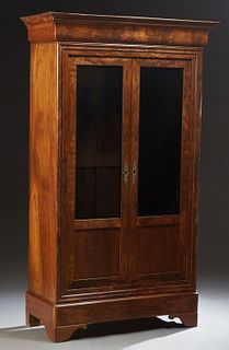 French Louis Philippe Carved Walnut Bookcase, 19th c., the stepped cavetto crown over double doors with glazed lower panels, flanked by highly figured