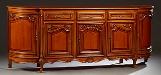 French Louis XV Style Carved Cherry Sideboard, 20th c., the stepped shaped parquetry inlaid top over two frieze drawers, above two fielded panel cupbo