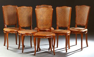 Set of Six French Louis XV Style Carved Cherry Dining Chairs, 20th c., the arched curved caned back over a bowed cane seat, on scrolled cabriole legs 