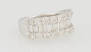 Lady's 14K White Gold Dinner Ring, with a central band of horizontal baguette diamonds, flanked by borders of round white diamonds, on a band with ree