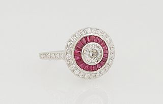 Lady's Platinum Dinner Ring, with a central .5 ct. round diamond within a border of baguette rubies and an outer border of small round diamonds, on a 