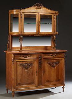 French Carved Walnut Marble Top Sideboard, c 1900, with an oval beveled curved glass display cabinet above a rear beveled mirror, on floral carved cur