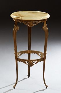French Louis XV Style Onyx and Brass Gueridon, early 20th c., the ogee edge circular top over a pierced skirt, on tripodal cabriole legs with toupie f