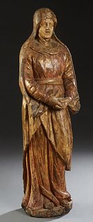 Large Continental Carved Gilt Wooden Female Santo, 18th/19th c., with her hands clasped in prayer, with original gilt, on an integral circular base, H