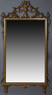 Italian Style Gilt Overmantel Mirror, 20th c., the pierced floral and urn carved crest over a polychromed frame with pierced leaf mounts on the sides,