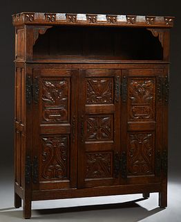 French Provincial Renaissance Style Carved Oak Sideboard, 19th c., the scrolled crown over open storage above three highly carved fielded panel doors 