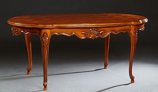 French Louis XV Style Oval Carved Cherry Drawleaf Dining Table, 20th c., the stepped edge shaped parquetry inlaid top over a serpentine skirt, on scro