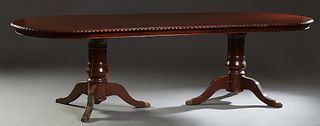 English Carved Mahogany Georgian Style Double Pedestal Dining Table, 20th c., the stepped oval gadrooned edge top on double urn form pedestals with fo