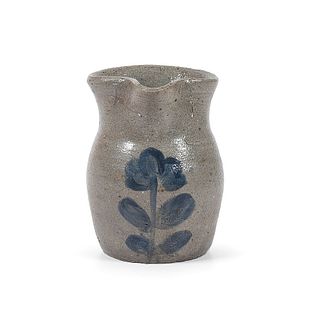 A Diminutive Stoneware Syrup or Cream Pitcher With Cobalt Flower