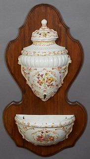 French Provincial Earthenware Lavabo, early 20th c., consisting of a reservoir over a basin, both with relief floral and leaf decoration on a shaped c