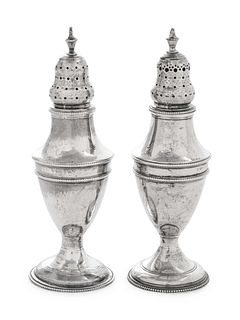 A Near Pair of George III Silver Casters