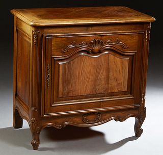 French Louis XV Style Carved Walnut Confiturier, 20th c., the stepped parquetry inlaid rounded corner and edge top over a wide fielded panel cupboard 