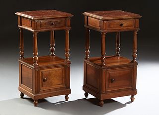 Pair of French Carved Walnut Marble Top Nightstands, c. 1870, the inset highly figured rouge marble over a frieze drawer, on turned reeded supports to