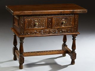 Spanish Style Carved Beech Lamp Table, 20th c., the rectangular top over two deep drawers, on turned trestle bases, joined by lappet carved stretchers