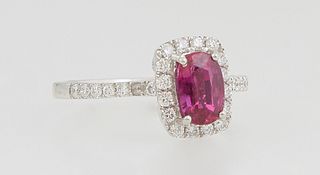 Lady's Platinum Dinner Ring, with a 1.06 ct. oval ruby atop a border of small round diamonds, the shoulders of the band also mounted with round diamon