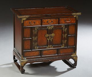 Diminutive Chinese Brass Mounted Carved Elm Tansu, early 20th c., the rectangular top over three frieze drawers and a double door cupboard with brass 