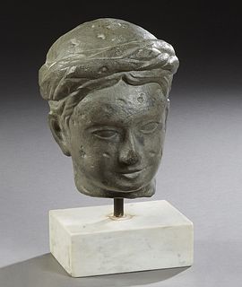 Oriental School, "Bust of a Man," 20th c., carved stone, presented on an iron support to a marble plinth, H.- 13 1/2 in., W.- 7 1/2 in., D.- 7 1/4 in.