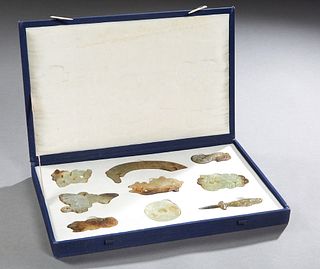 Group of Nine Chinese Carved Flat Jade Pieces, 20th c., consisting of a butterfly, 5 dragons, 2 fish, and a circular pendant, presented in a fitted cl