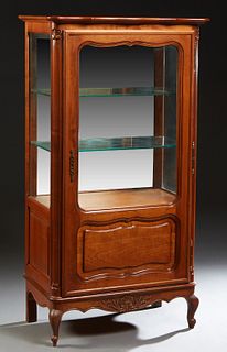 French Louis XV Style Carved Cherry Vitrine, 20th c., the serpentine rounded corner and edge top over a door with a glazed upper panel and a fielded l