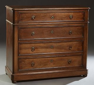 French Louis Philippe Carved Walnut Commode, 19th c., the canted corner rounded edge top over a frieze drawer and three deeper drawers, on a plinth ba