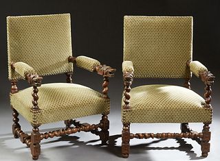 Pair of Henri II Style Carved Oak Fauteuils, late 19th c., the high square upholstered back over upholstered arms with dragon terminals, to a trapezoi