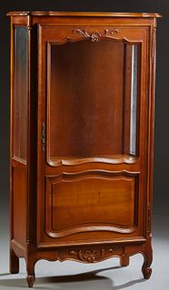French Louis XV Style Carved Cherry Curio Cabinet, 20th c., the stepped serpentine top over a single door with a glazed upper panel, over a fielded lo