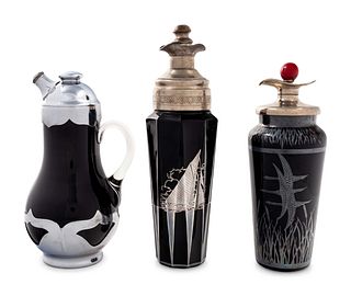A Group of Three Black Glass Cocktail Shakers