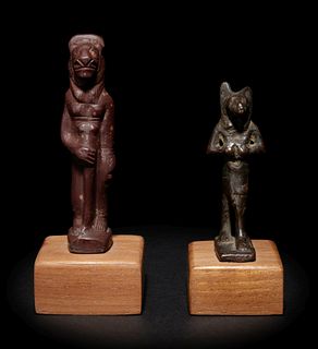 An Egyptian Stone Striding Bastet and an Egyptian Bronze Anubis 
Height of taller example 3 1/8 inches; height of shorter example 2 1/8 inches.