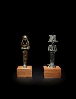 An Egyptian Bronze Ushabti and an Egyptian Bronze Osiris
Height of taller example 3 inches; height of shorter example 2 7/8 inches.