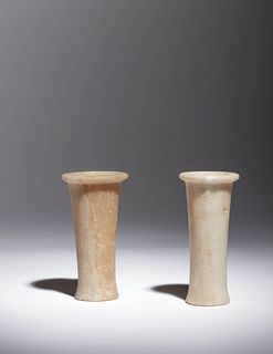 Two Egyptian Alabaster Columnar Vessels
Height of taller example 4 1/2 inches; height of shorter example 4 3/8 inches.