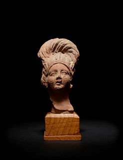 A Romano-Egyptian Terra Cotta Bust
Height 3 1/2 inches.