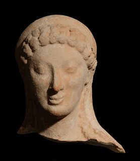 A Greek Terracotta Head
Height 4 inches.