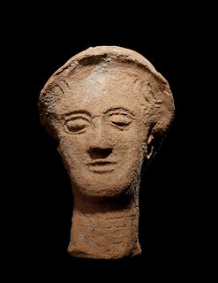 A Greek Terracotta Head
Height 10 inches.