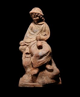A Greek Terracotta Seated Scholar Holding a Wine JugHeight 6 5/8 inches.