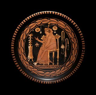 An Apulian Red-Figured Plate with a Seated Goddess or PriestessDiameter 9 inches.