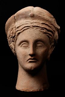 A Roman Terracotta Votive Head 
Height 10 inches.