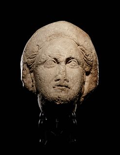 A Cypriot Limestone Head of a Goddess, Perhaps Aphrodite or Demeter
Height 9 1/2 inches.