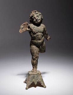 A Roman Bronze Figure of Eros
Height 6 1/2 inches.