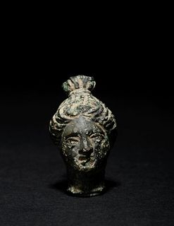 A Roman Bronze Head of a Goddess or Noblewoman
Height 1 inch.