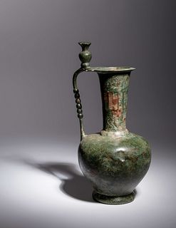 An Umayyad or Early Abbasid Bronze Ewer with a Pomegranate
Height 11 1/4 inches.