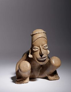 A Jalisco Pottery Crouching Figure
Height 6 5/8 x width 6 3/4 inches.