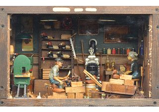 Well made diorama of workshop with man carving and woman painting.