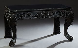 Victorian Style Carved Mahogany Console Table, 20th c., the rectangular top over a wide pierced scroll carved skirt, on pointed cabriole legs, now wit
